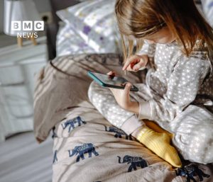 French teenager using a smartphone, illustrating France's new social media ban under 15
