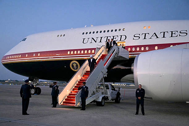 Qatar Air Force One upgrades — President Trump's new red, white and gold Boeing 747-8 presidential jet on the tarmac